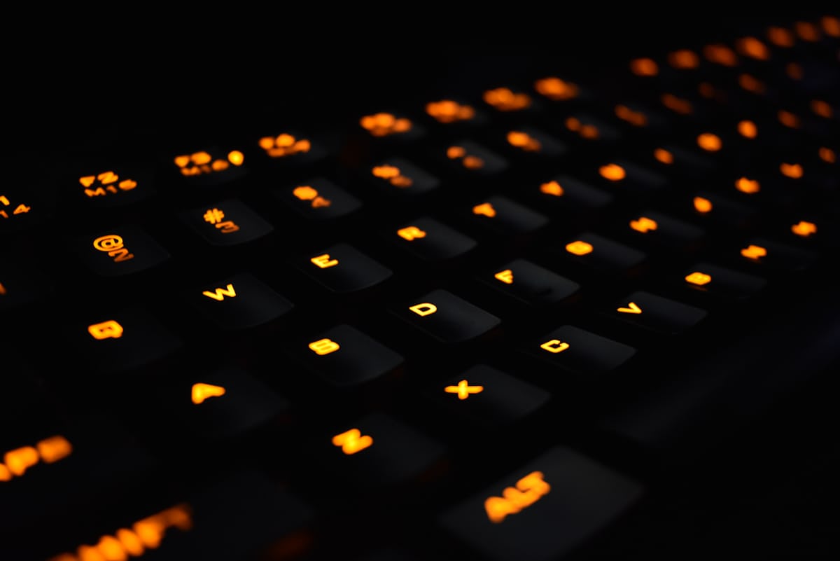 Minimal desk with keyboard and ambient purple lighting